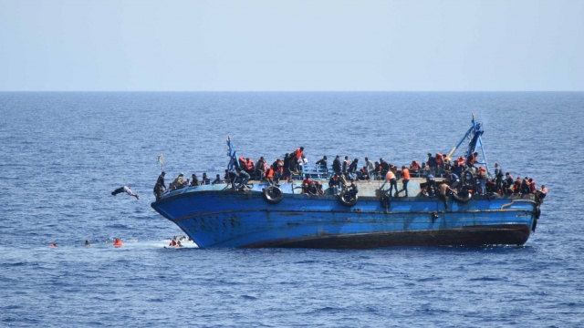 Migrant boat tipping in the Mediterranean Sea.