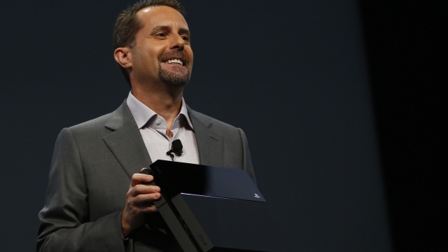 Andrew House, the CEO of Sony Computer Entertainment Inc., holds up a Playstation 4 at the E3 2016 conference.
