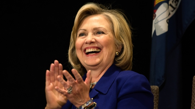 Clinton smiles and claps while campaigning in New York.