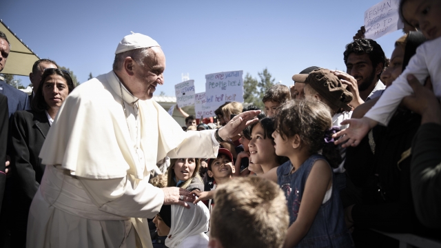 In this handout image provided by Greek Prime Minister's Office, Pope Francis meets migrants in Greece.