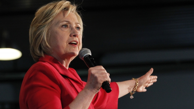 Hillary Clinton, in a red blazer, addresses the crowd at a 2016 rally.