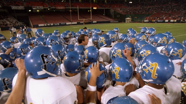A high school football team gets pumped up before a game.