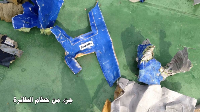 A blue object that says "EgyptAir" is displayed among other wreckage found by investigators.