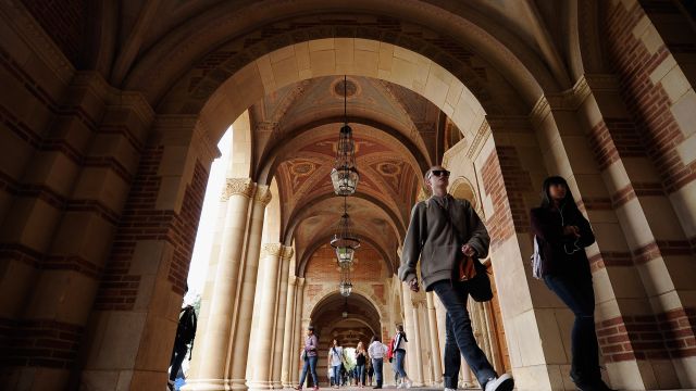 Students walk near Royce Hall on the campus of UCLA