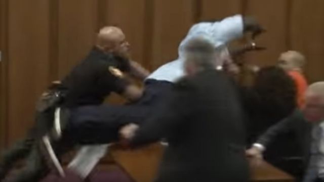 Van Terry rushes Michael Madison in a Cleveland court after Madison was sentenced to death for killing Terry's daughter.