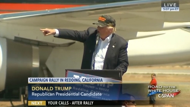 Donald Trump points to a rally attendee.