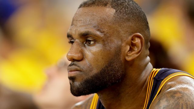LeBron James of the Cleveland Cavaliers sits on the bench during Game 2 of the 2016 NBA Finals against Golden State Warriors.