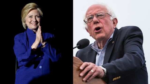 A side by side photo of Hillary Clinton in a blue suit and Bernie Sanders in a navy blue blazer.