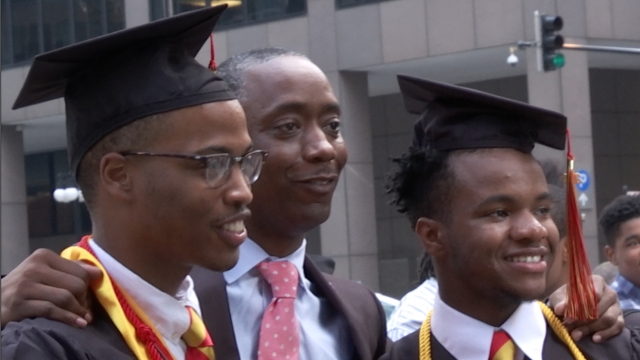 Two Urban Prep Academies graduates pose for pictures after the school's commencement ceremony.