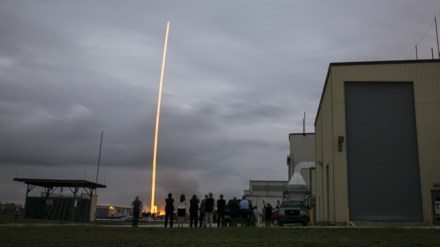A photograph of the Orion team members watching the United Launch Alliance Delta IV Heavy rocket with NASA.