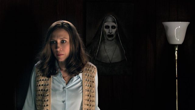 A scary picture of a nun on the wall behind Vera Farmiga as Lorraine Warren in "The Conjuring 2"