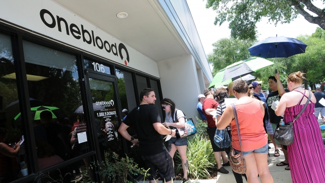 People wait outside the OneBlood Donation Center in Orlando, Florida