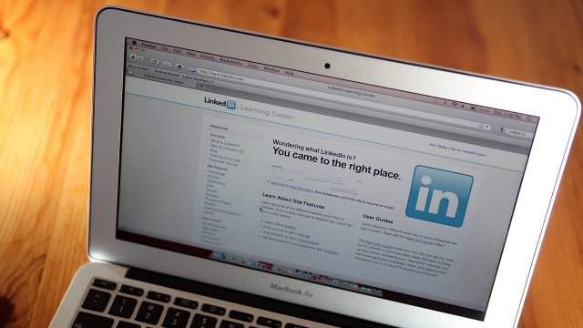 The LinkedIn logo is displayed on the screen of a laptop computer.
