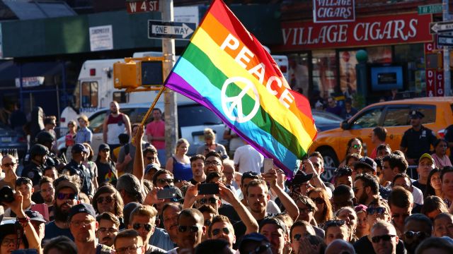 People gather outside of the Stonewall Inn as a vigil is held following the massacre that occurred at a gay Orlando nightclub