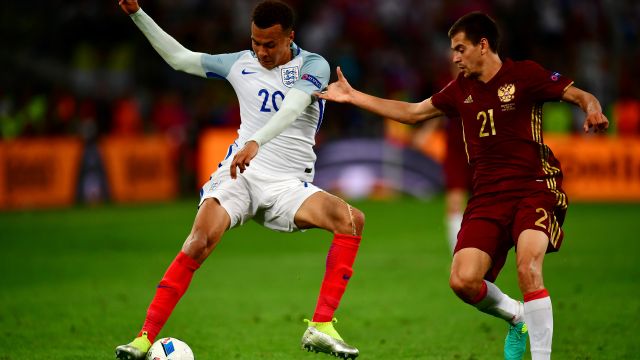 Dele Alli of England holds off Georgi Schennikov of Russia during the UEFA EURO 2016 match between England and Russia.
