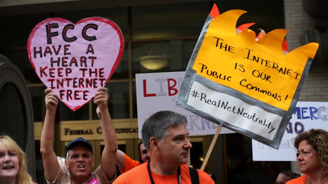 Demonstrators protest outside Federal Communications Commission as the commission is about to meet to discuss net neutrality.