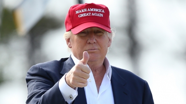 Donald Trump gives a thumbs-up sign.
