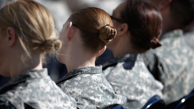 Female soldiers listen to a commencement speech.