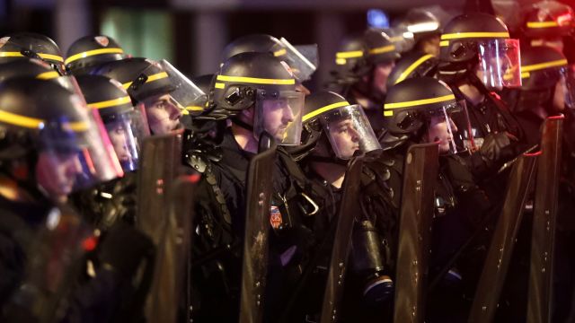 Police officers look on during a pause in clashes with England fans on June 16, 2016 in Lille, France.