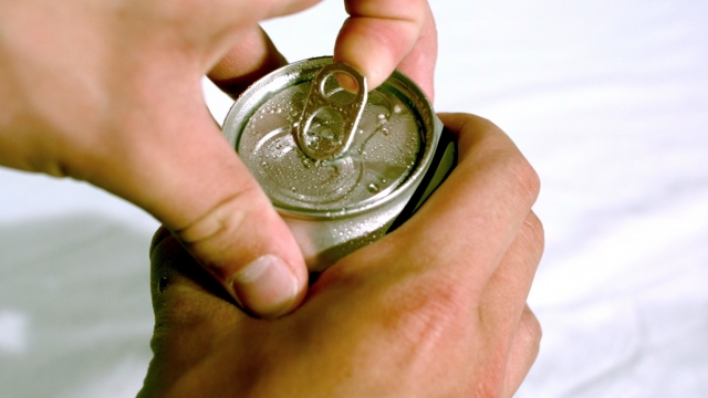 A person opening a can.