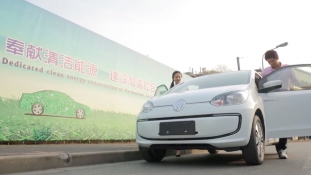 A couple gets into one of Volkswagen's electric vehicles.