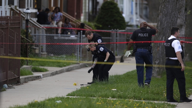 Chicago police officers stand inside a taped off area in Chicago.