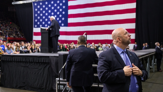Members of the U.S. Secret Service watch the crowd as Democratic presidential candidate Bernie Sanders speaks.