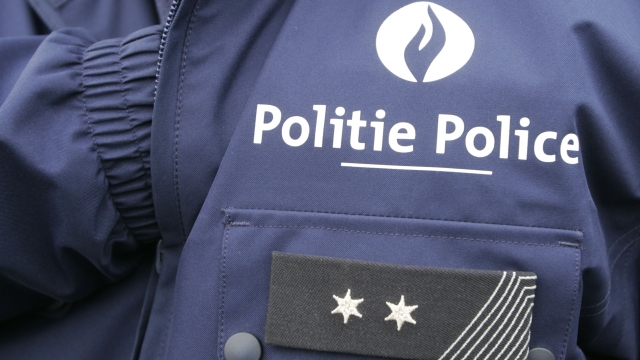 The logo on a police uniform is written in both French and Flemish in Brussels.