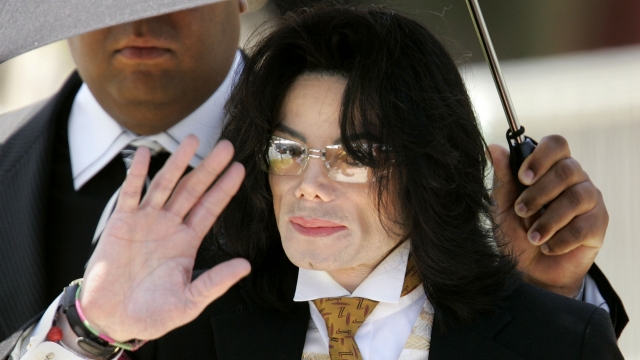 Michael Jackson waves to fans as he exits the courthouse after his child molestation trial is given over to the jury.