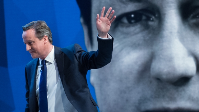 British Prime Minister David Cameron waving.