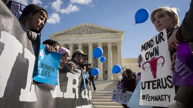Pro-choice advocates (right) and anti-abortion advocates (left) rally outside of the Supreme Court in Washington, D.C.