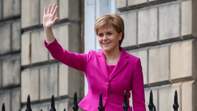 Scottish First Minister Nicola Sturgeon waving and smiling
