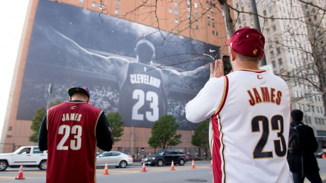 Fans take pictures of a LeBron James #23 of the Cleveland Cavaliers banner outside Quicken Loans Arena.