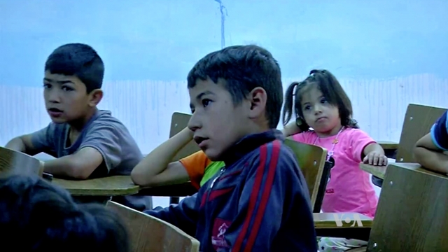 Children sit at desks at an orphanage in Iraqi Kurdistan