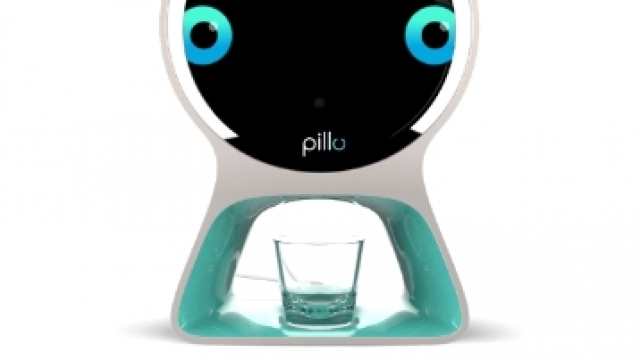 A round robot with a screen as the face and a pill dispenser in the bottom.