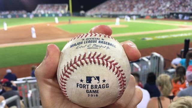 Baseball collector Zack Hample shows off a baseball he snagged at the Fort Bragg MLB game.