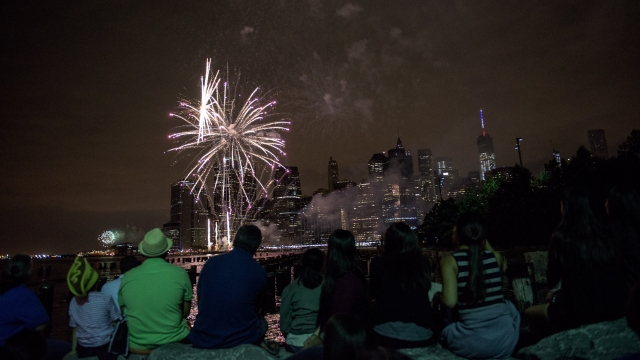 People watch Macy's Fourth of July Fireworks from Brooklyn Bridge Park on July 4, 2015.