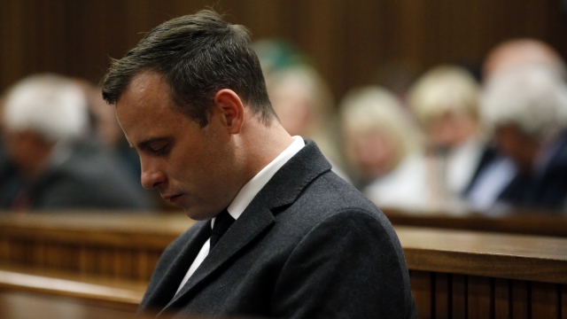 Oscar Pistorius bows his head during a hearing in his murder trial.