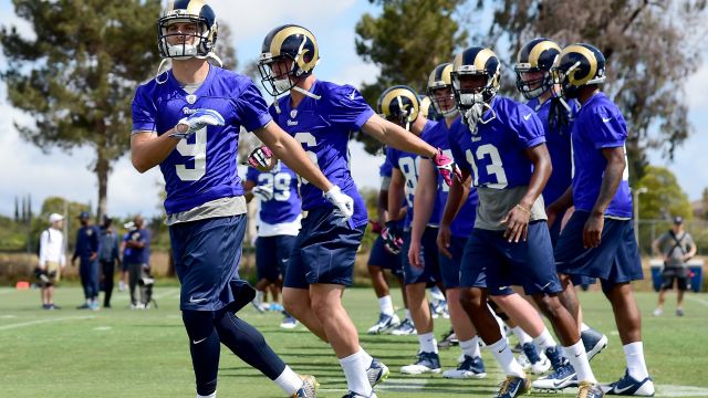 Athletes warm up in the Los Angeles Rams rookie camp.