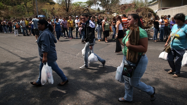 Venezuelans get food during the country's food shortage.