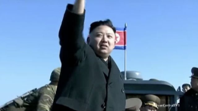 Kim Jong-un waves to soldiers.