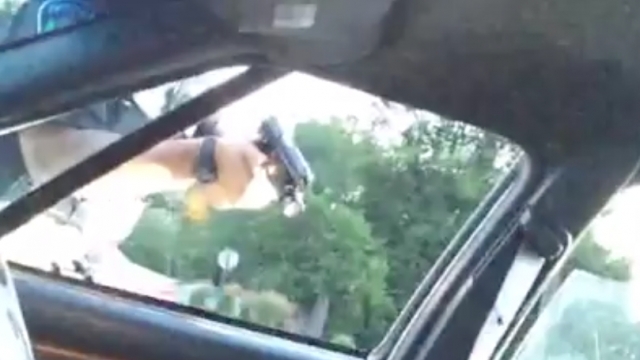 Police officer holds gun after shooting Philando Castile during traffic stop