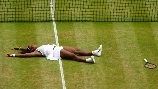 Serena Williams collapses on the court after winning the 2016 Wimbledon ladies' singles title.