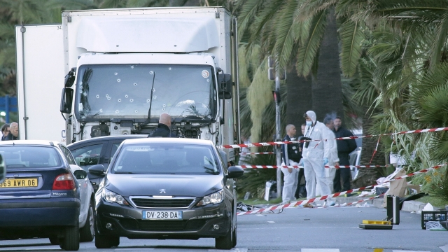 Forensic police investigate a truck at the scene of a terror attack on the Promenade des Anglais.
