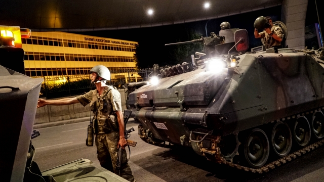 Turkish soldiers stand guard near army' tanks as they enter the Ataturk Airport during the coup attempt.