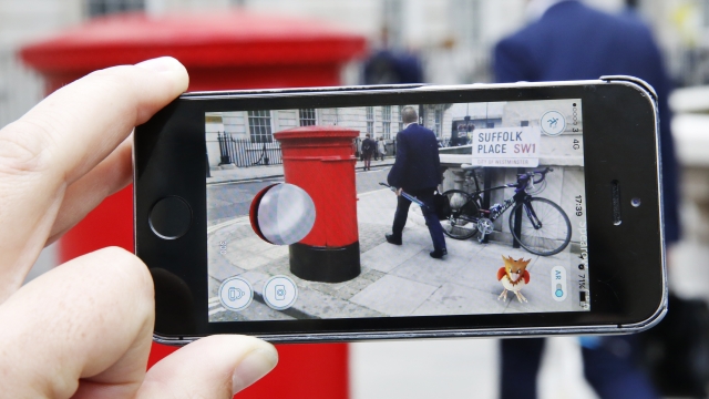 A Spearow, a Pokémon character appears in a London street during a game of "Pokémon Go."