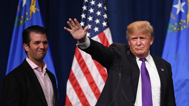 Donald Trump Jr. (L) looks on as his father, Republican presidential candidate Donald Trump, on February 23, 2016.