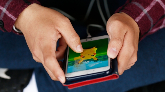 A man plays "Pokémon Go" on his smartphone.