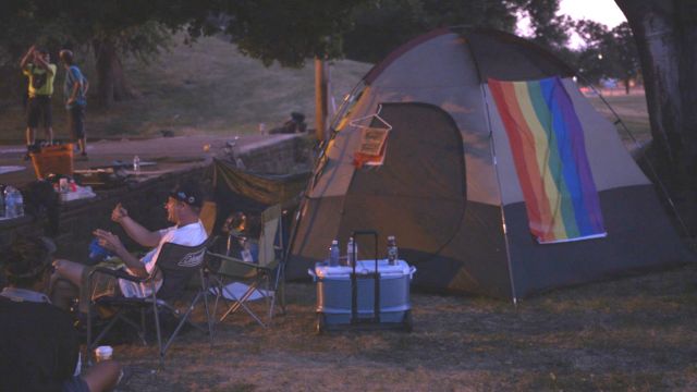 Convention-goers relax for the night in a park in Cleveland.