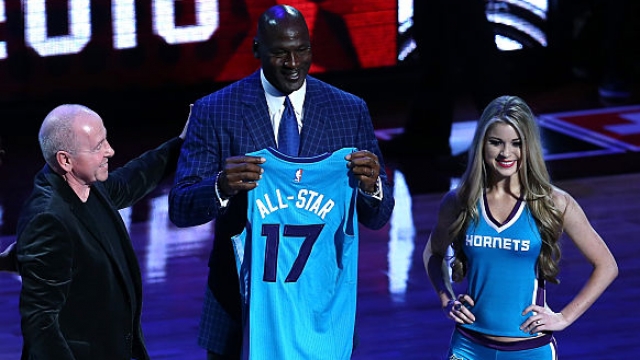 Michael Jordan holds a jersey signifying Charlotte as the host city for the 2017 All-Star game.